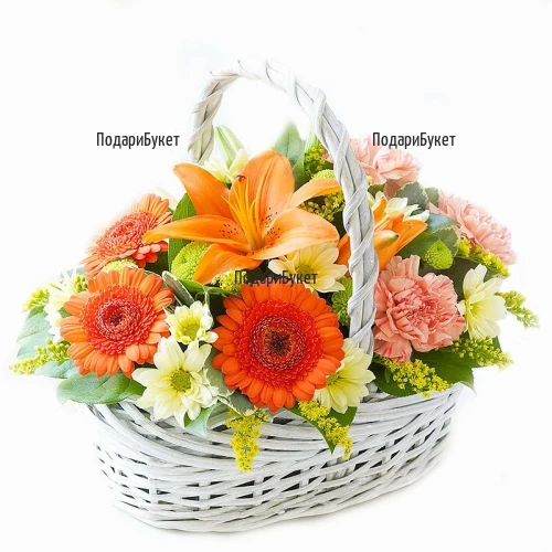 Flower delivery - basket with fresh flowers and greenery
