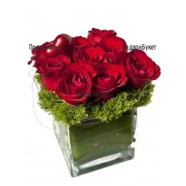 Romantic arrangement with red roses in glass cube
