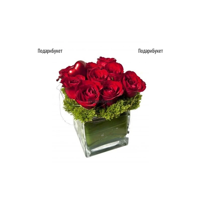 Romantic arrangement with red roses in glass cube