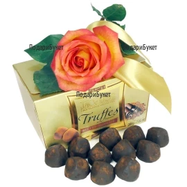 One orange rose with a bow and Truffles chocolates with a ribbon - romantic, delicious gift for the beloved one.