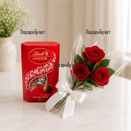 Три червени рози и луксозни бонбони Lindor Cornet - перфектен податък за романтични моменти.