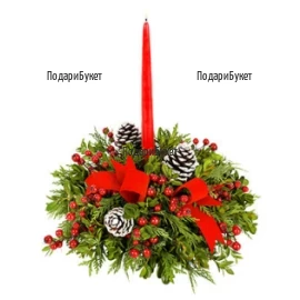 Classic Christmas centerpiece, arranged with fresh greenery - pine twigs, natural materials and red candle