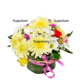 Small, cheerful floral arrangement, composed of colorful chrysanthemums and decorations.